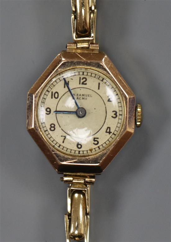 A ladys 9ct gold wrist watch, retailed by Samuel, on a 9ct gold flexible bracelet.